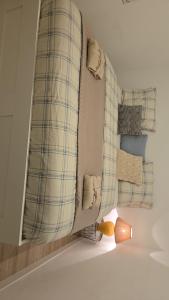 a room with a mirror and a lamp on the floor at Maison spacieuse in Saint-Julien-de-Concelles