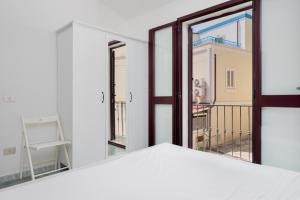 a room with a window and a view of a balcony at Casa Del Marinaio in Cala Gonone