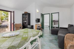 a living room with a table and a couch at Casa Del Marinaio in Cala Gonone