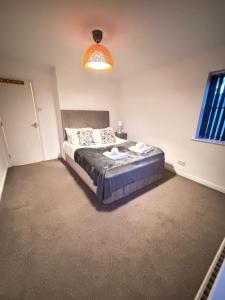 a bedroom with a bed and a window and a lamp at Luxury One-Bedroom House with Free Parking in Slough +7 photos