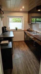 a kitchen with a counter and a sink and a window at Strandschnecke 2 in Scharbeutz