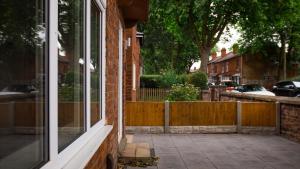 a brick house with a window and a fence at HouseSleeps6-Garden-Parking-Familly&Contractors in Walsall