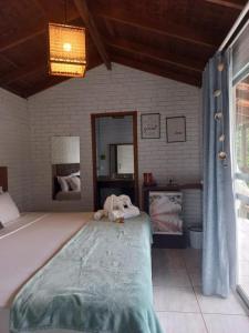 a bedroom with a large bed with a stuffed animal on it at Villa in Governador Celso Ramos