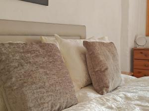two pillows sitting on top of a bed at 2 Hope Cottage in Spilsby