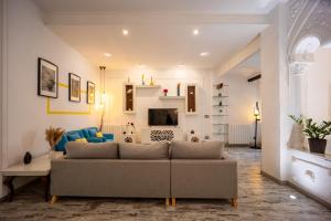a living room with a couch and a tv at Portrait Boutique Villa in Valencia