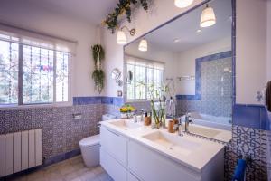a bathroom with a sink and a toilet and a tub at Portrait Boutique Villa in Valencia +46 photos