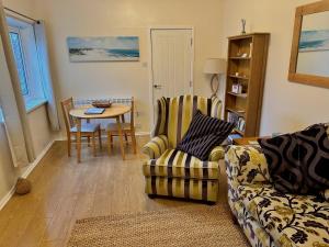 a living room with a couch and a table at Rockpool Cottage in Beadnell