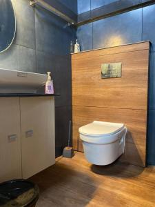 a bathroom with a white toilet and a sink at NATURESGrandeur#ModernCabinTropical HABITAT#Kerala in Pathanāmthitta +89 photos