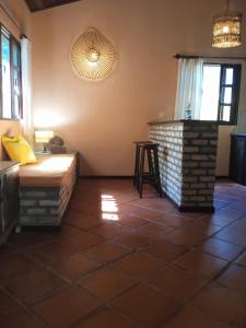 a living room with a bed and a fireplace at Pousada Aquarela Pipa in Pipa
