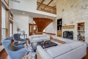 a living room with two couches and a fireplace at 22-Acres Mansion - Pool Party Venue Games & More in Garland