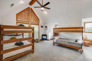 a bedroom with two bunk beds and a ceiling fan at 22-Acres Mansion - Pool Party Venue Games & More in Garland +98 photos