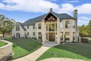 a large stone house with a large front yard at 22-Acres Mansion - Pool Party Venue Games & More in Garland