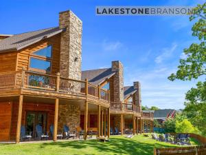 a log home with a wrap around deck at Lodge 17 in Branson