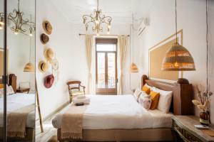 a bedroom with a bed and a mirror at Portrait Boutique Villa in Valencia