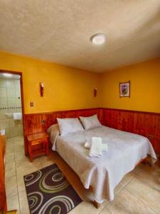 Voodi või voodid majutusasutuse Hostal & Cabañas Don Juan toas