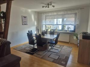 a dining room with a table and chairs at Ferienhaus Zimmer in Perl
