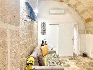 a living room with a couch in a room at Antica Pietra in Polignano a Mare