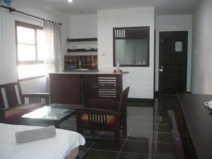 a living room with a table and a dining room at FAA Apartment in Vientiane