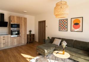 a living room with a couch and a table at Riverside - Apartmán Dita in Vrchlabí