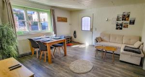 a living room with a table and a couch at Ruhige Wohnung mit schöner Aussicht in Bolsterlang