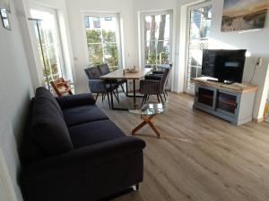 a living room with a couch and a table at Ostseemeerchen in Zingst +9 photos