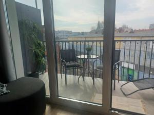 a view of a balcony with a table and chairs at One-room apartment Nyska Residence Free garage!!! in Wrocław