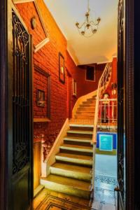 a staircase in a house with a brick wall at 1826 Heritage Rooms in Taksim +25 photos