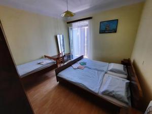 a bedroom with two beds and a window at Rooms Vid&Rok in Mošćenička Draga +7 photos