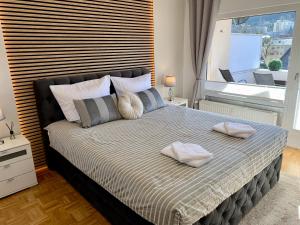 a bedroom with a large bed with two pillows on it at Bergliebe 6 mit großer Terrasse, Tiefgarage & Lift in Bad Harzburg