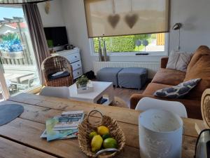 a living room with a wooden table with baskets of fruit at florence 1 nr 52 in Serooskerke