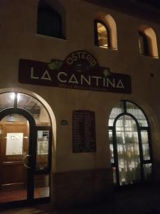 a building with a sign for a la cantina at appartamento incantevole in Mirandola