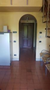 a hallway with a door in a room with chairs at appartamento incantevole in Mirandola