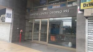 an entrance to a building with a glass door at Departamento Edificio Centro Osorno in Osorno +1 photo