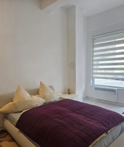 a bedroom with a purple bed with a window at MIRO Apartmani in Pale