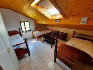 a attic bedroom with two beds and a skylight at Rooms Vid&Rok in Mošćenička Draga