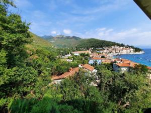a small town on a hill next to the ocean at Rooms Vid&Rok in Mošćenička Draga