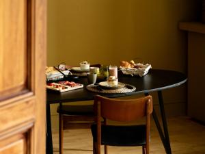 a black table with food on top of it at LE DOMAINE DE FERRAT in Mirambeau