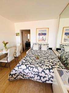 a bedroom with a bed and a table and chairs at Marina Baie des Anges - Studio - Villeneuve-Loubet in Villeneuve-Loubet