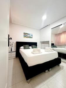 a bedroom with a large bed and a bathroom at Holiday Apartment in Torrevieja +18 photos