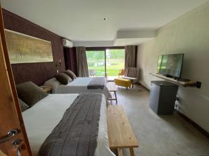 Villa SecaにあるCasa Septemのベッド2台とテレビがあるホテルの部屋