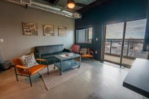 a living room with a couch and chairs and a table at Brewhalla Hotel in Fargo