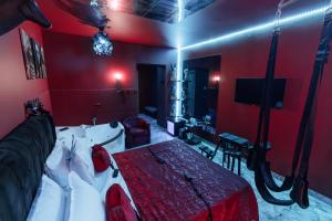 a red room with a bed and a tv at Romeo Nights - Private Rooms - Adults Only in Bucharest