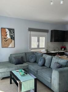 a living room with a couch and a table at Eolos Villa in Parga