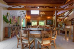 a dining room with a wooden table and chairs at Fazenda Góes in Conde