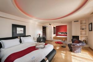 a bedroom with a large bed with a round ceiling at Iakovakis Suites & Spa in Koropi