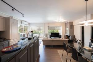 a large kitchen with a living room and a couch at Luxe Bliss 2BR, Glyfada in Athens