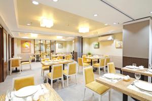 a dining room with tables and chairs in a restaurant at Belian Hotel in Tagbilaran City