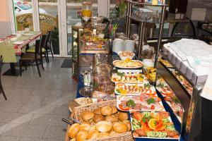 a buffet of food on display in a restaurant at Hotel Sonne am Meer in Norddeich