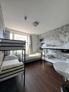 a bedroom with two bunk beds and a sink at Amigo Budget Hotel in Amsterdam +29 photos