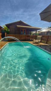 a large swimming pool in front of a house at Pousada Sal e Mar in Imbituba +13 photos